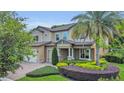 Charming two-story home with manicured landscaping, stone accents, and a spacious three-car garage at 1938 Filly Trl, Oviedo, FL 32765