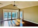 Living room with vaulted ceiling, ceiling fan and sliding glass doors at 204 Quayside Cir # 601, Maitland, FL 32751