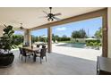 Covered patio with ceiling fans and dining table overlooking the pool and backyard at 2118 Whiting Trl, Orlando, FL 32820