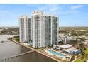 View of community with two pools, tennis court, boat pier and walkway at 241 Riverside Dr # 902, Holly Hill, FL 32117