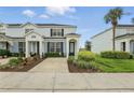 Well-maintained townhouse with landscaping, driveway, and covered entryway at 2531 Maneshaw Ln, Kissimmee, FL 34747