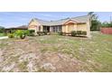 Inviting single-story home featuring manicured landscaping, a two-car garage, and a welcoming front entrance at 2741 Beaver Dr, Deltona, FL 32725