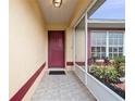 Inviting covered front porch area with tiled floor, screen, and freshly painted front door at 2741 Beaver Dr, Deltona, FL 32725