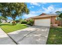 View of the home's driveway leading to the two car garage door on a sunny day at 2809 Gulf Winds Ct, Oviedo, FL 32765