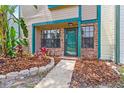Up close, inviting front entrance featuring a modern door and well-maintained garden at 2930 Candela Ct, Apopka, FL 32703