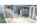 An aerial view of a beachside condo building, showcasing its proximity to the ocean at 3023 S Atlantic Ave # 2050, Daytona Beach, FL 32118