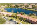 Aerial view of the property showing its location near a scenic lake and community pool at 3065 Yellow Lantana Ln, Kissimmee, FL 34747
