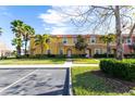 Attractive townhome with colorful exterior, red tile roof, and lush greenery at 3065 Yellow Lantana Ln, Kissimmee, FL 34747