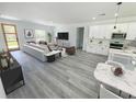 Bright living room open to kitchen features gray flooring and contemporary furnishings at 3159 Sw 127Th Lane Rd, Ocala, FL 34473