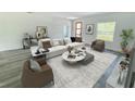 Modern living room featuring a white sofa, marble tables, and neutral decor at 3159 Sw 127Th Lane Rd, Ocala, FL 34473
