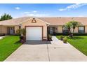 Charming single-story home with a well-maintained lawn and two-car garage in a peaceful neighborhood at 3404 Village Green Ct, St Cloud, FL 34772