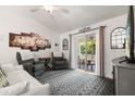 Inviting living room featuring comfortable seating, decorative artwork, and a sliding door to the outdoor patio at 3404 Village Green Ct, St Cloud, FL 34772