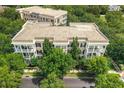 Aerial view of complex surrounded by lush trees, showcasing the building's architecture and setting at 4385 Wardell Pl # 13, Orlando, FL 32814