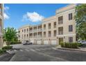Exterior view showcasing beige-colored building with balconies, parking area, and well-maintained landscaping at 4385 Wardell Pl # 13, Orlando, FL 32814