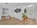 Inviting foyer with wood-look floors, decorative shelving, and a stylish front door at 4390 Carolwood St, Orlando, FL 32812