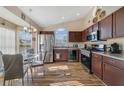Eat-in kitchen features stainless appliances, wood cabinets, and a sunny breakfast nook at 4533 Oakbrook Ct, Kissimmee, FL 34746