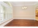 Elegant dining room featuring hardwood floors, crown molding, and abundant natural light at 492 Lanarkshire Pl, Apopka, FL 32712