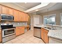 Modern kitchen featuring stainless steel appliances, granite countertops, and tile backsplash at 492 Lanarkshire Pl, Apopka, FL 32712
