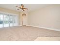 Bright and airy living room with plush carpet and sliding glass doors leading to the pool at 492 Lanarkshire Pl, Apopka, FL 32712