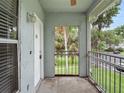 Cozy screened porch showcasing an exterior view of the landscaped grounds and parking area at 507 Northlake Dr # 507, Sanford, FL 32773