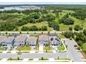 An aerial view of a well-designed home in a desirable neighborhood surrounded by lush greenery and a tranquil lake at 5677 Cedar Chase Dr, St Cloud, FL 34771
