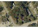 Aerial view of an overgrown lot surrounded by trees, with a red boundary line marking the property at 578 3Rd St, Daytona Beach, FL 32117