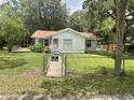 A quaint single-story home featuring a manicured front lawn and a charming picket fence at 578 3Rd St, Daytona Beach, FL 32117