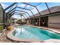 Relaxing screened in pool with outdoor seating and lounging furniture perfect for entertaining at 806 Spring Island Way, Orlando, FL 32828