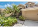 Beautiful home exterior with lush landscaping, a two-car garage, and a charming walkway leading to the entrance at 985 N Lake Claire Cir, Oviedo, FL 32765