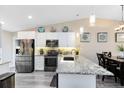 Bright kitchen featuring white cabinets, granite countertops, and stainless steel appliances at 102 Sand Pine Cir, Sanford, FL 32773