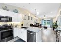 Modern kitchen featuring granite countertops, stainless steel appliances, and an open layout at 102 Sand Pine Cir, Sanford, FL 32773