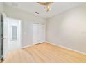 Comfortable bedroom with light wood floors, a ceiling fan, and closet, creating a welcoming space at 13850 Amelia Pond Dr, Windermere, FL 34786