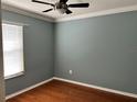 Bedroom with neutral paint, wood flooring, and natural light streaming through the window at 14147 Mailer Blvd, Orlando, FL 32828
