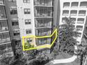 Beautiful view of the condo exterior highlighting the private balcony space, screened-in lanai, and lush landscaping at 14501 Grove Resort Ave # 3239, Winter Garden, FL 34787