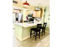 Well-lit kitchen with updated appliances, breakfast bar, and stylish light fixtures for a modern feel at 151 E Washington St # 508, Orlando, FL 32801
