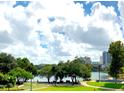 Scenic lake view showcasing park, buildings, blue sky, and fluffy white clouds at 151 E Washington St # 508, Orlando, FL 32801