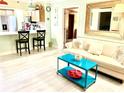 Bright living room featuring kitchen with breakfast bar and comfortable seating area at 151 E Washington St # 508, Orlando, FL 32801