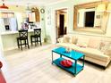 A vibrant living space offering a kitchen with breakfast bar and comfortable sitting area with unique decor at 151 E Washington St # 508, Orlando, FL 32801