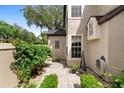 Picturesque courtyard featuring stone pavers, lush greenery, and a tranquil outdoor ambiance at 1529 Farrindon Cir, Lake Mary, FL 32746