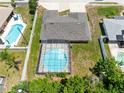 Aerial view of a home with a screened-in pool and a spacious backyard at 1736 Saxon Blvd, Deltona, FL 32725