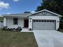 Well manicured single story home with a two car garage and fresh landscaping at 1754 35Th Nw St, Winter Haven, FL 33881