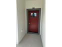 Close up of a bold red front door with glass insert and grey trim at 1754 35Th Nw St, Winter Haven, FL 33881