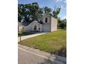 Charming two-story home with neutral vinyl siding, white trim, green lawn, and a one-car garage at 1791 Iroquois Dr, Apopka, FL 32703