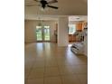 Spacious living room with tile flooring, stair access, and natural light from the backyard at 1791 Iroquois Dr, Apopka, FL 32703