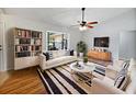 Bright living room features a stylish black and white rug, modern furniture and a ceiling fan at 1818 Portview Ave, Deltona, FL 32738