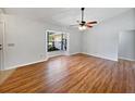 Spacious room with hardwood flooring and ceiling fan, filled with natural light from the large window at 1818 Portview Ave, Deltona, FL 32738