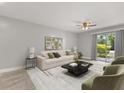 Bright living room with contemporary decor, neutral paint, and sliding door to backyard area at 1924 Lake Atriums Cir # 52, Orlando, FL 32839