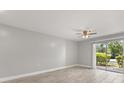 Bright living room with neutral paint, tile floor and a sliding door to backyard area at 1924 Lake Atriums Cir # 52, Orlando, FL 32839