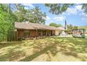Brick home with green lawn, tree, and a rented storage unit in the driveway at 236 Longhorn Dr, Apopka, FL 32712