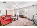 Bright living room with bay window, neutral carpet, and comfortable seating area at 236 Longhorn Dr, Apopka, FL 32712